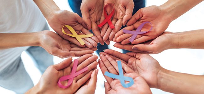 Female Hands Holding Various Colorful Ribbons to represent the various different cancers.